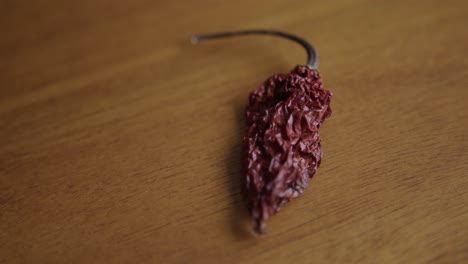 close up pan right of a dried ghost pepper on a table