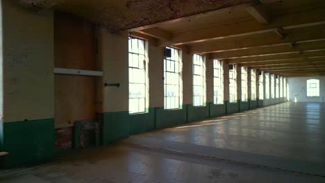 aerial beginning with a close-up of windows at a belfast spinning mill warehouse on a sunny day