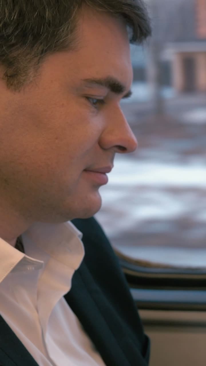 Man in Suit Riding Train