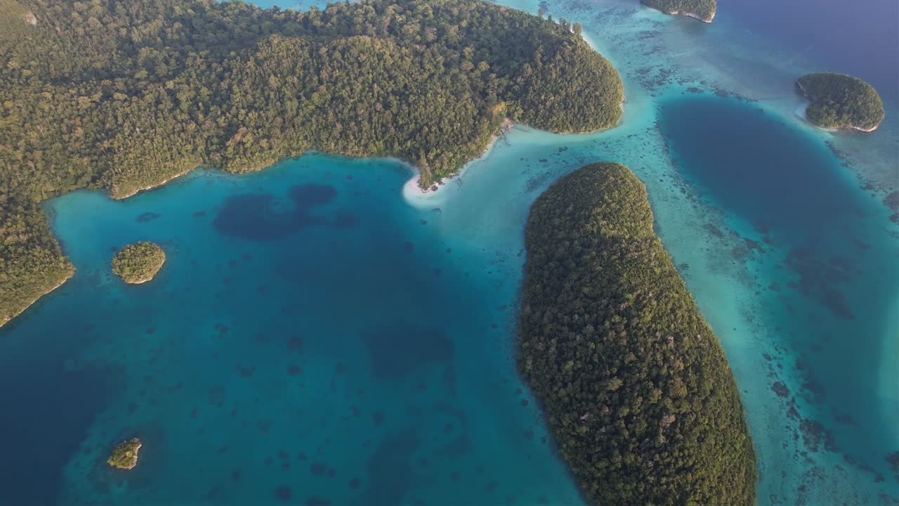 Stunning view on islands, coral reefs and white sandy beach washed in turquoise waters of Raja Ampat, Wayag, Indonesia, Papua