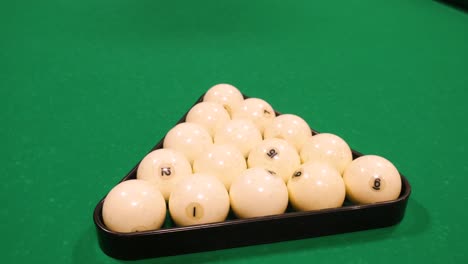 billiard balls in triangle on pool table