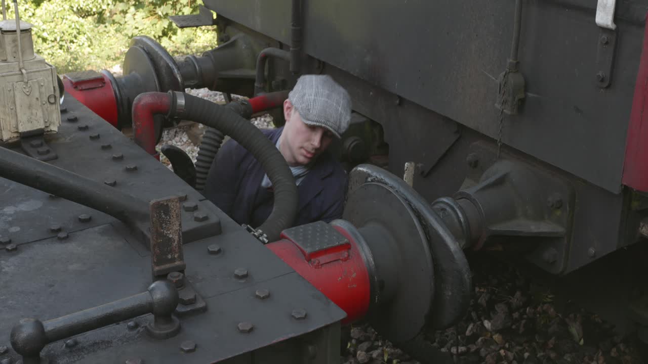 Informal mechanic working on a historic Steam train in East Somerset Railway
