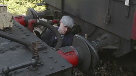 informal mechanic working on a historic steam train in east somerset railway