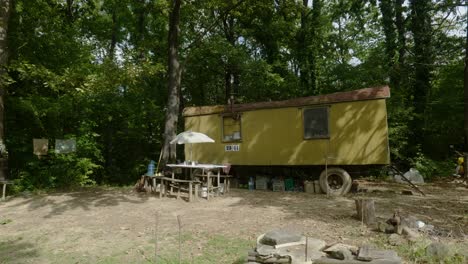 Camping-off-grid-with-metal-box-camper-trailer-outdoor-woodland-scene