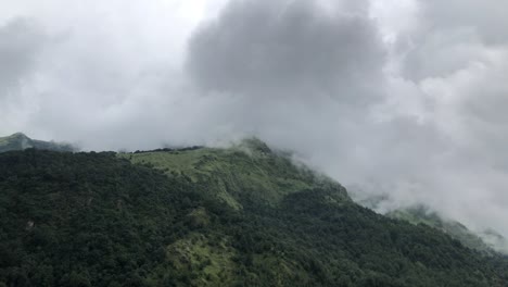 day timelapse of clouds movement over the top of a hill on a cloudy day