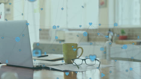 animation of network of connections with icons over empty office with laptop