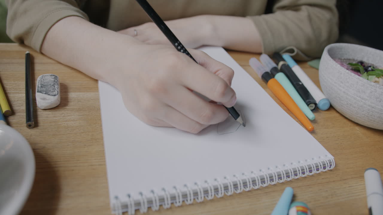 Woman Drawing in a Cafe