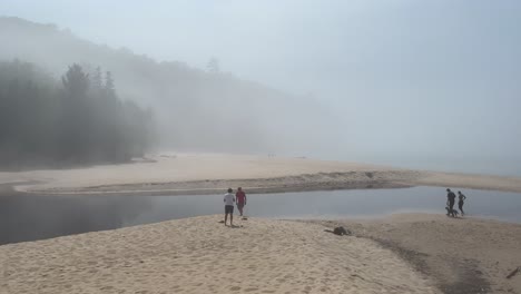 very foggy beach with people walking miners beach munising michigan lake superior