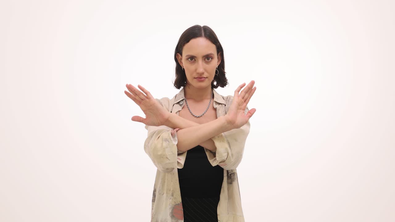 Woman Making X Gesture with Crossed Arms to Signal Stop or No