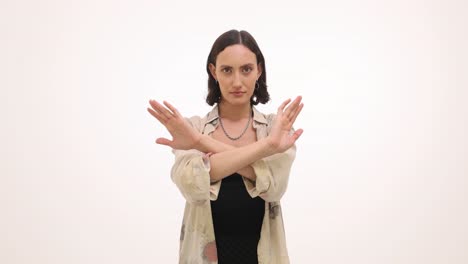 woman making x gesture with crossed arms to signal stop or no