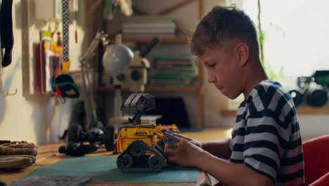 boy building a robot toy at home