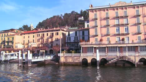 POV-from-a-boat-of-the-shores-of-Lake-Como-with-the-town-of-Bellagio-and-the-Italian-Alps-in-background