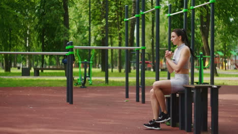 Female-athlete-performs-side-lunges-work-out-her-legs-and-jumping-in-the-Park-in-slow-motion.-Beautiful-woman-playing-sports-in-the-Park.