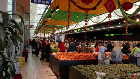 shoppers explore fruit and vegetable stalls