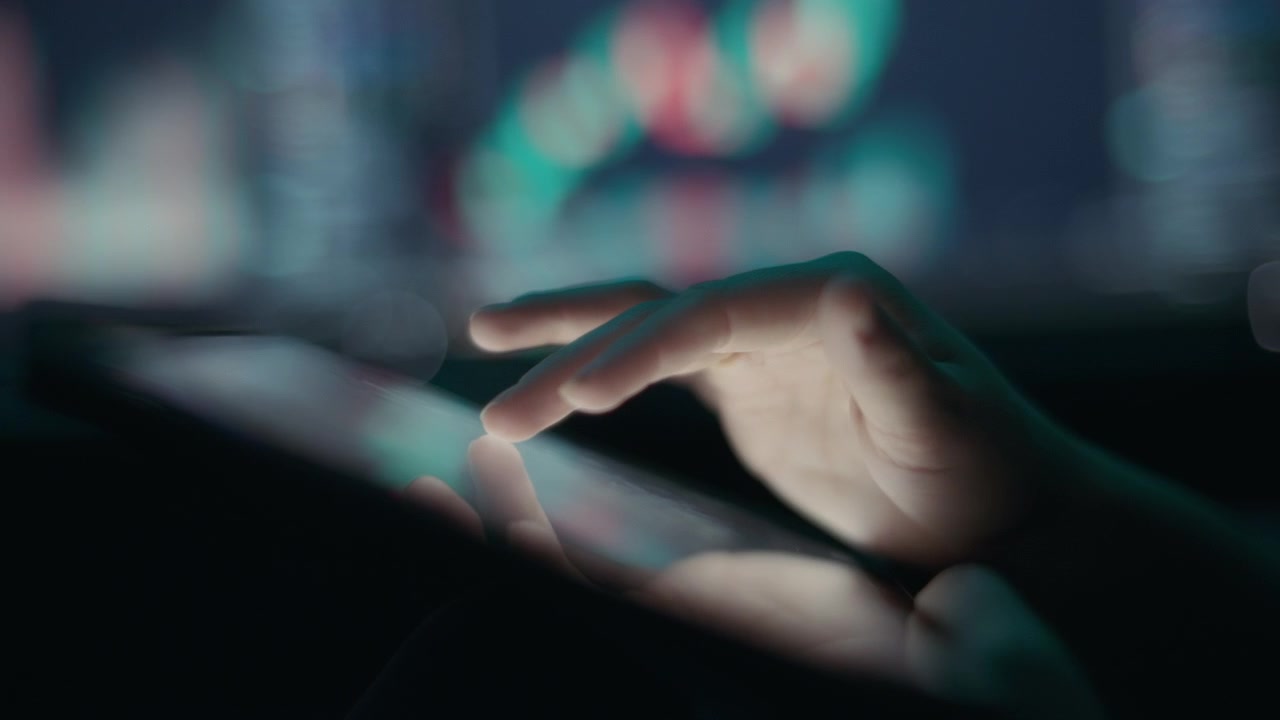 Person analyzing stocks using graphs and charts on a tablet app