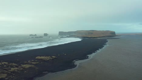 mysterious landscape, reynisfjara black sand beach, drone shot of iceland coast