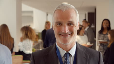 portrait of mature male delegate during break at conference