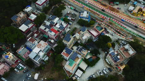 Rotating-birds-eye-view-of-a-local-group-of-houses-next-to-a-road