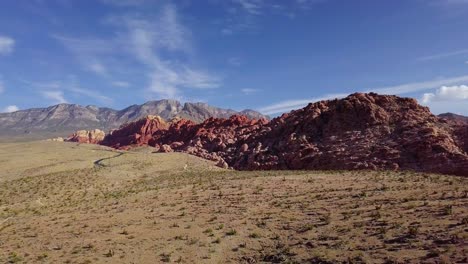 aerial drone view over desert towards sandstone mountains, in red rock, arizona