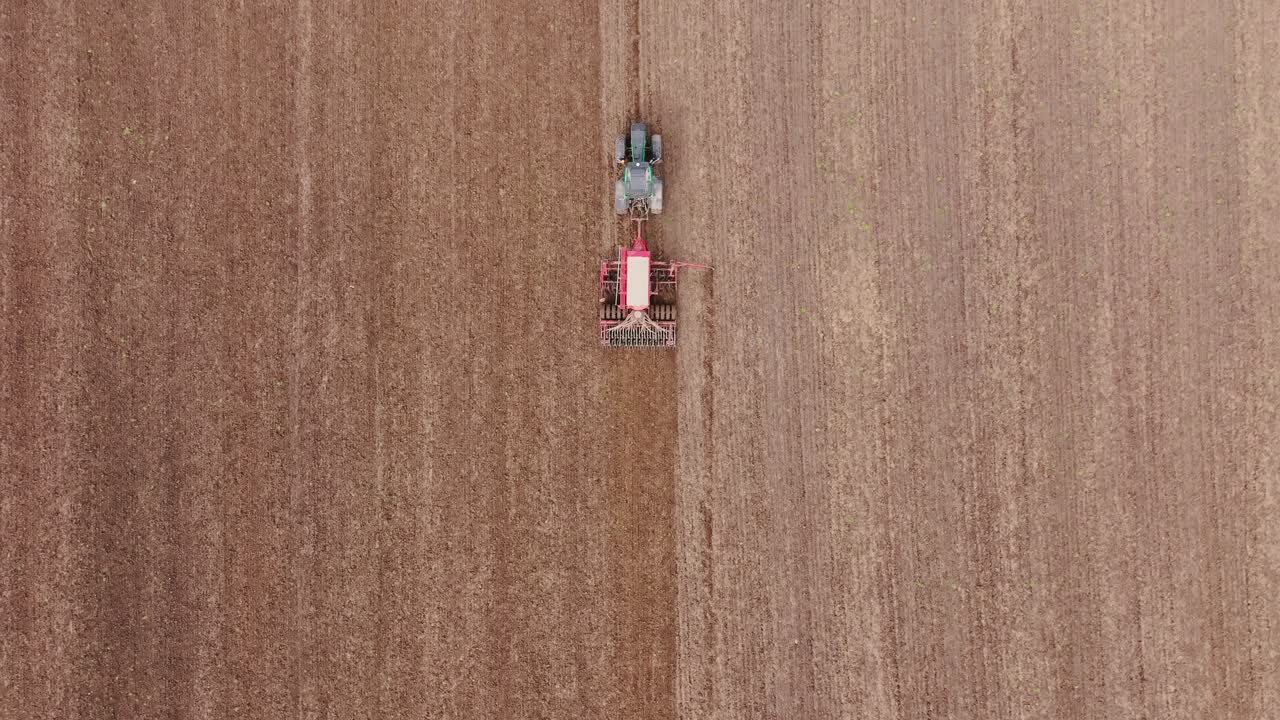 Top down of machine in vast bare land as metaphor for resource deficit farming