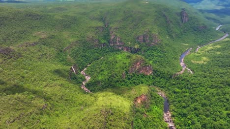 aerial view capturing cachoeira dos saltos waterfall cascading into the rio preto river, surrounded by lush vegetation and canyons in chapada dos veadeiros national park, goiás