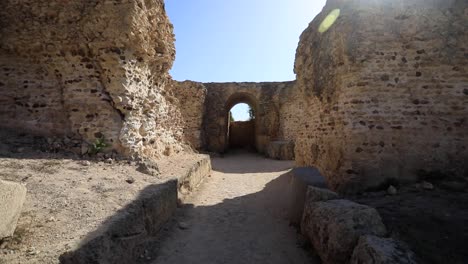 sunlit ancient roman ruins of carthage in tunisia, clear blue sky, historical ambiance