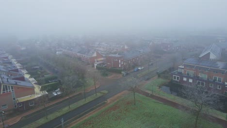 jib up of a beautiful suburban neighborhood covered in fog