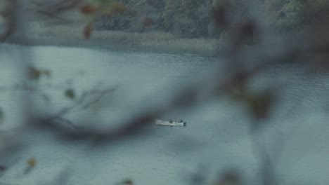 fishing boat trawling on lake in winter