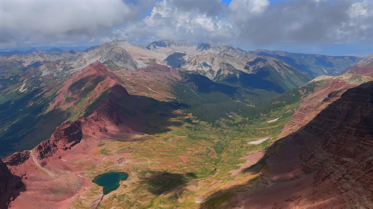 North Maroon Peak Aspen Snowmmass Maroon Bells Wilderness valley Capitol Peak Mount Snowmass Colorado summer panoramic view fog fourteener Elk Range Rocky Mountains rugged terrain pan left