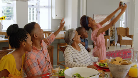 Multi-generation-family-taking-selfie-woth-mobile-phone-at-home-4k