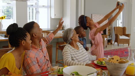 multi-generation family taking selfie woth mobile phone at home 4k
