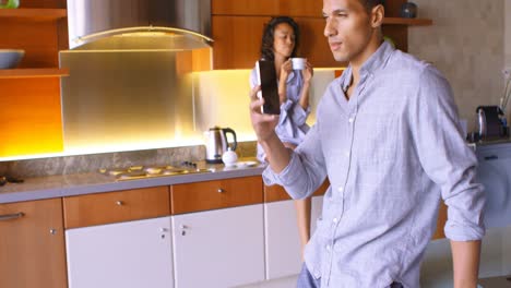 man talking on mobile phone while his partner having coffee in background 4k