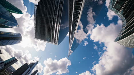 modern skyscrapers with sun and clouds, low angle view