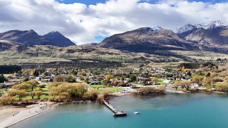 aerial view of lake, mountains, and town