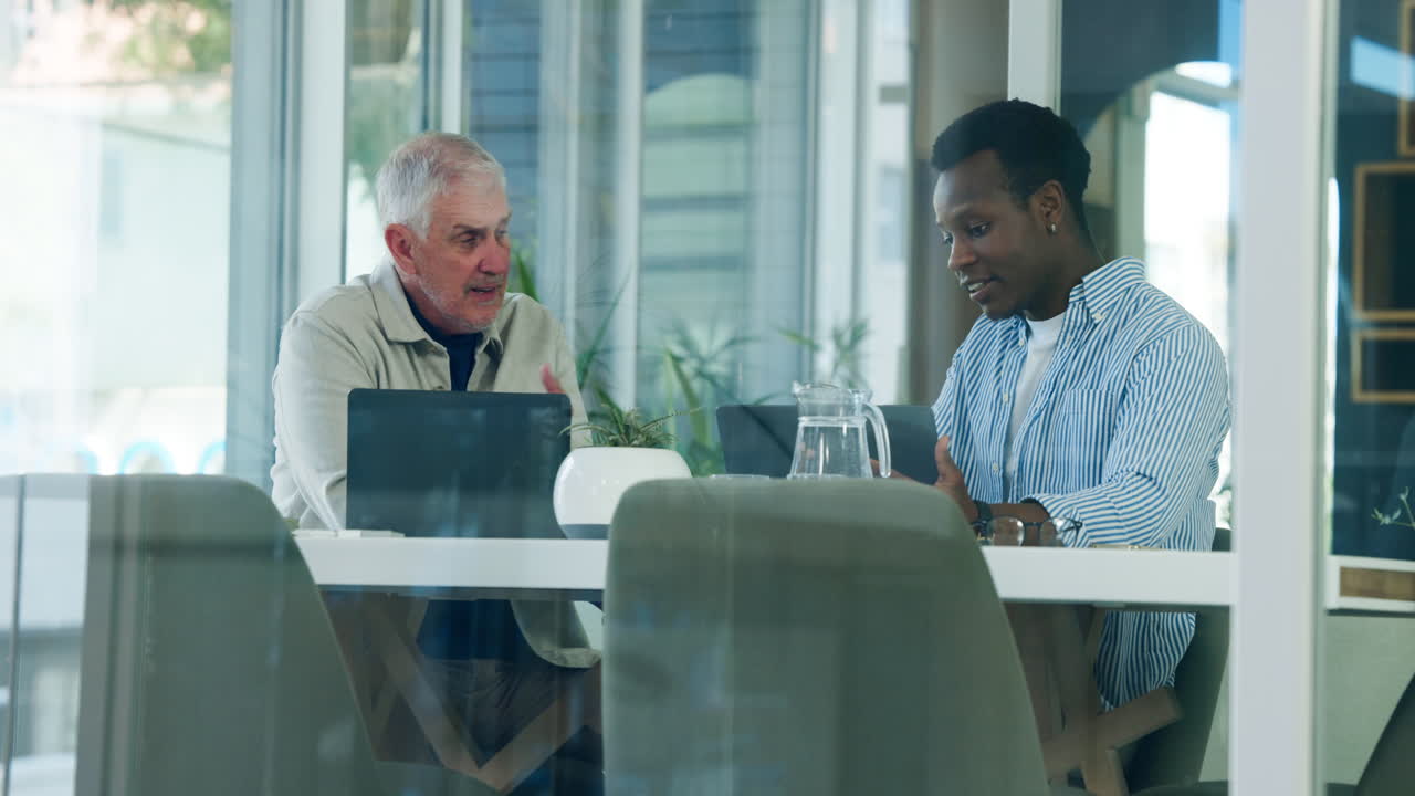 Two Diverse Businessmen Discussing Work in a Modern Office Meeting
