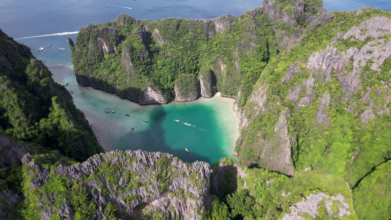 Revealing aerial drone view of Phi Phi Leh, Pileh Lagoon, Krabi province, Thailand. Amazing tropical island with clear turquoise water during a low tide , famous travel destination.