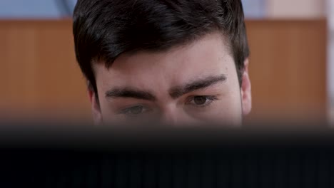 close-up of a person looking at a computer screen