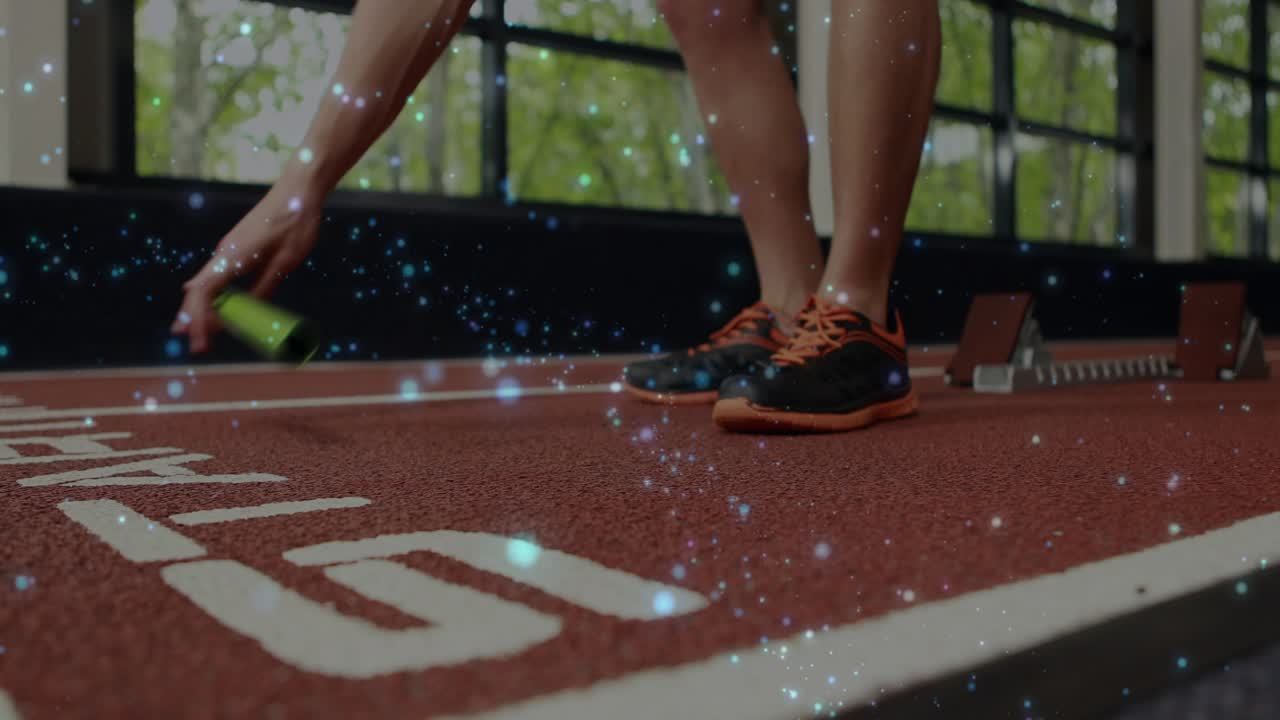 On starter call athlete hands and feet adjusting on lane while grabbing green baton for sprint