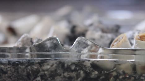 a ashtray full of cigarette butts close up