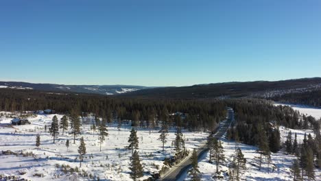 nesfjellet mountain during winter - clear sunny day ascending aerial revealing panoramic view above norway highlands towards rukkedalen and nesbyen