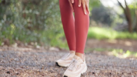 Runner-woman,-hands-and-ankle-pain-in-park