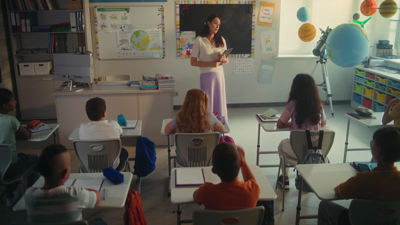 Female Teacher Calling Young Student to the Board During Science Lesson