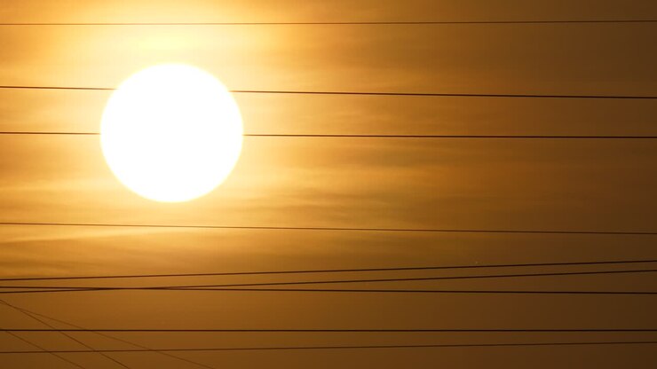 Large sun disc, thin optical Fiber-optic cables across sky, telephoto view