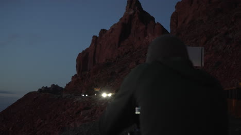 Photographer-at-dusk-getting-a-shot-on-the-side-of-the-highway-in-the-southwest-Arizona-desert-landscape---adventure,-focus,-passionate,-waiting,-idea,-creativity