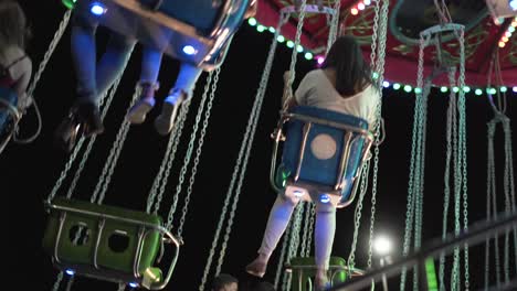 colorful carousel seats at night in a park