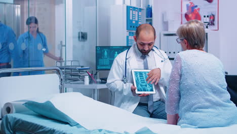 el médico presenta una tomografía de rayos x en una tableta digital