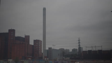 timelapse shot of grey clouds passing over the suvilahti power plant