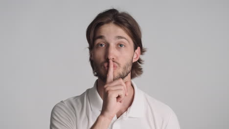 caucasian man in front of camera on gray background.