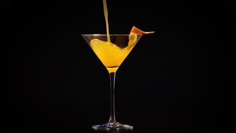 orange juice poured into glass with garnish