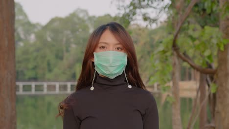 woman wearing a mask in a park